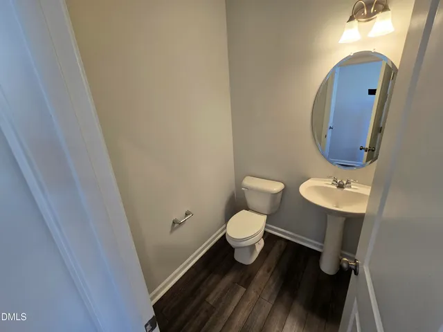 a bathroom with a toilet and a mirror