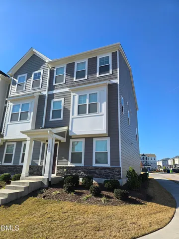 a front view of a building with a garden