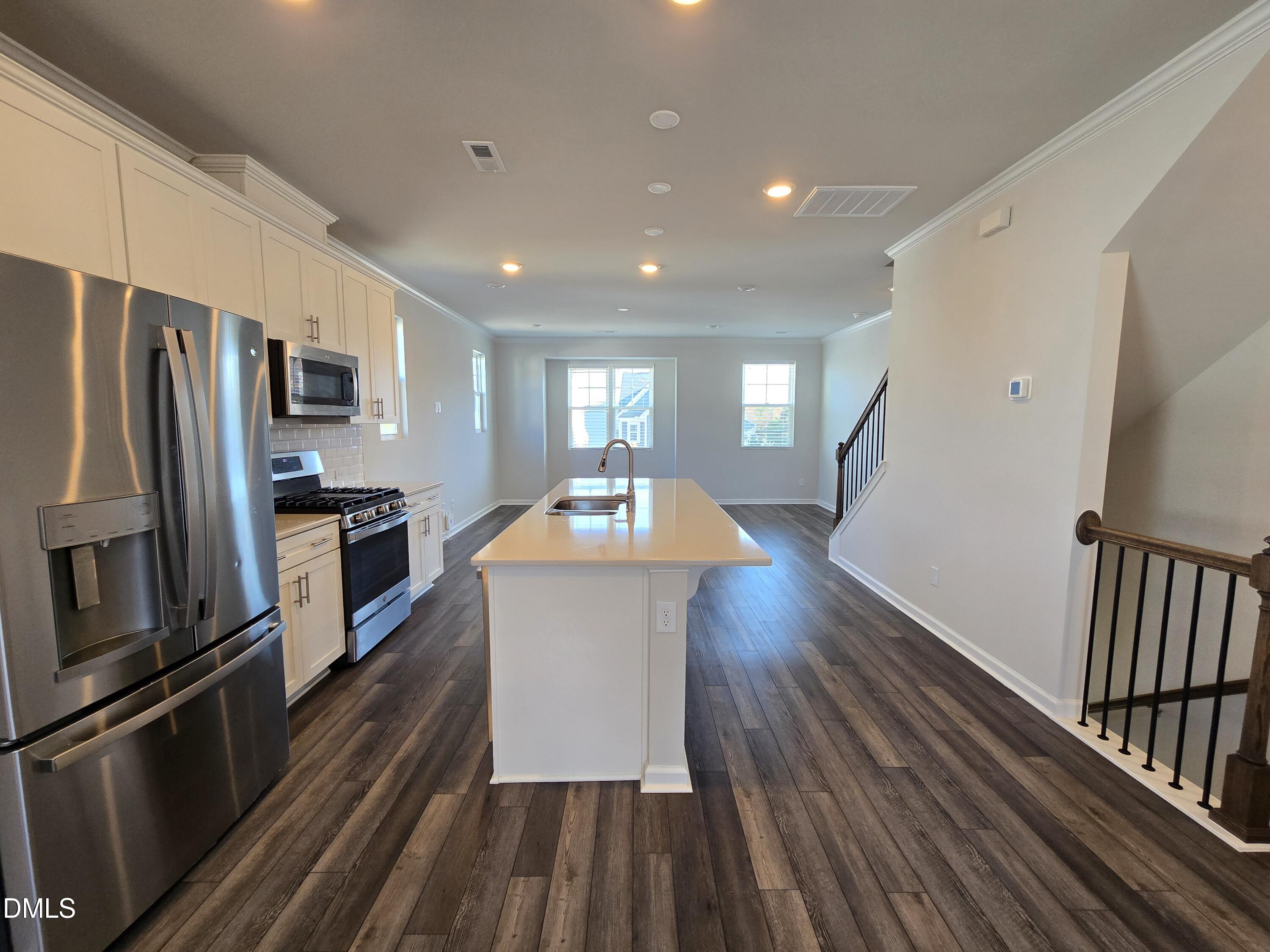 6309 Truxton Lane Raleigh, NC 27616 - Photo 22 of 41 a kitchen with sink a refrigerator and wooden floor