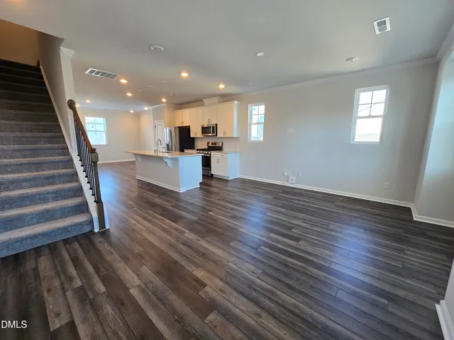 a view of kitchen and hall with wooden floor