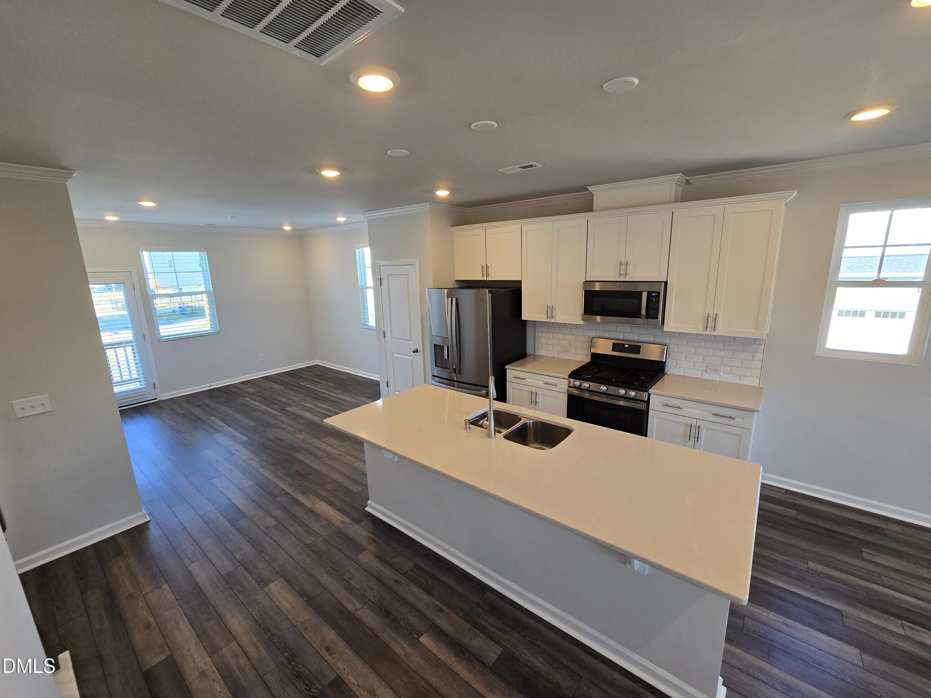 6309 Truxton Lane Raleigh, NC 27616 - Photo 27 of 41 a kitchen with wooden floor and window