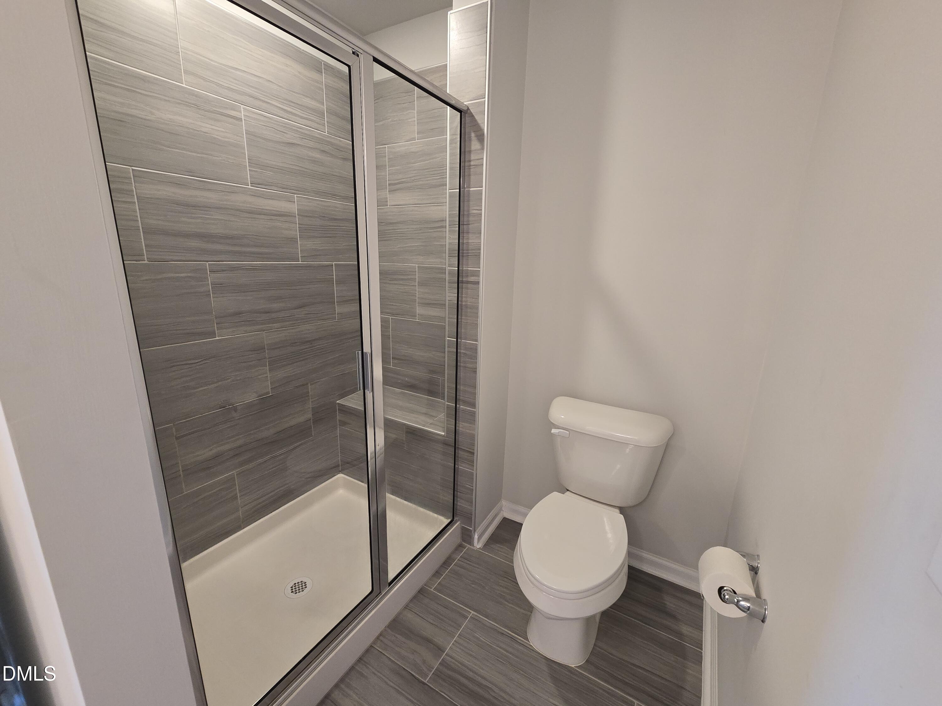 6309 Truxton Lane Raleigh, NC 27616 - Photo 32 of 41 a bathroom with a toilet and a shower