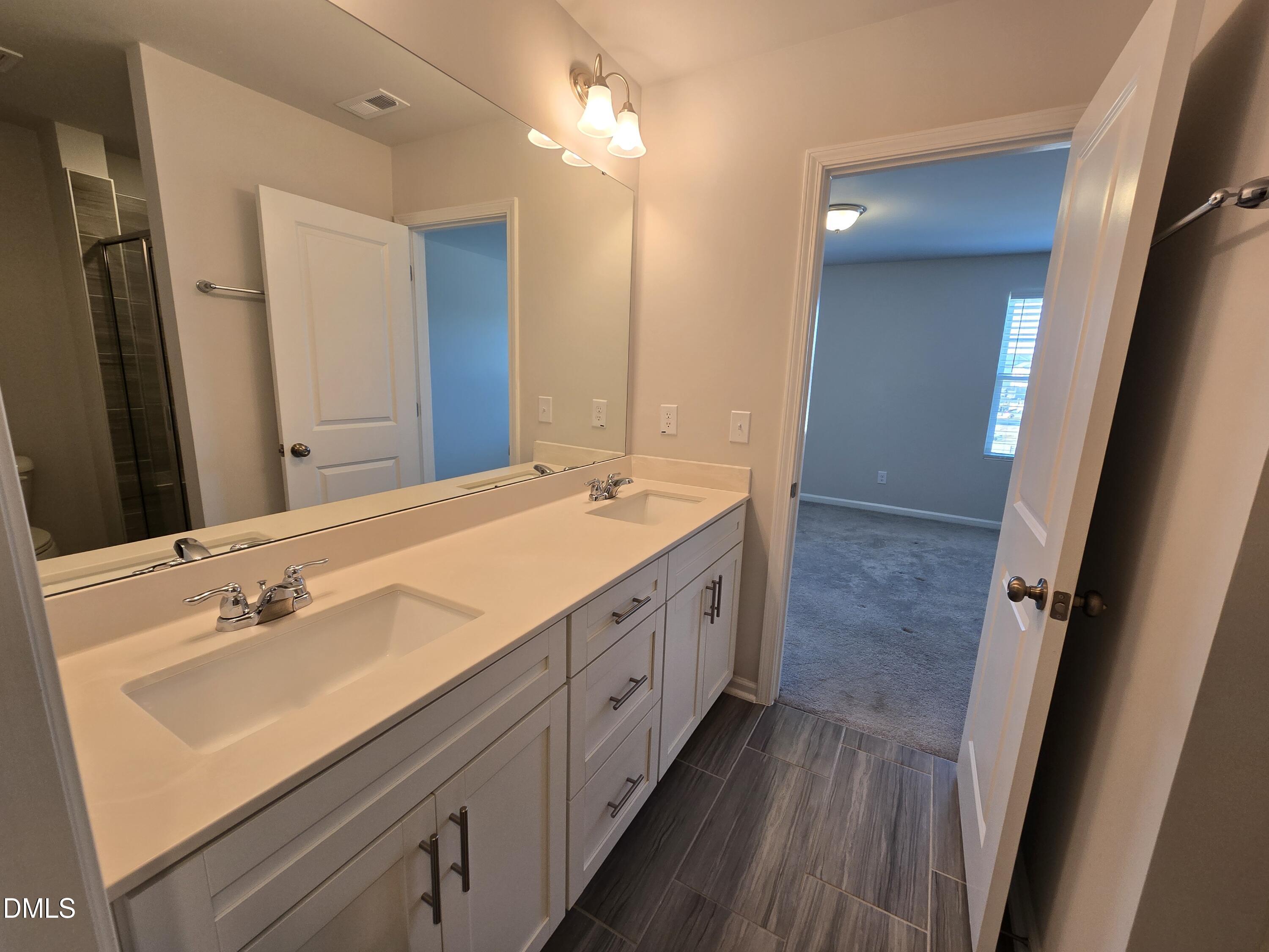 6309 Truxton Lane Raleigh, NC 27616 - Photo 34 of 41 a spacious bathroom with double vanity and mirrors