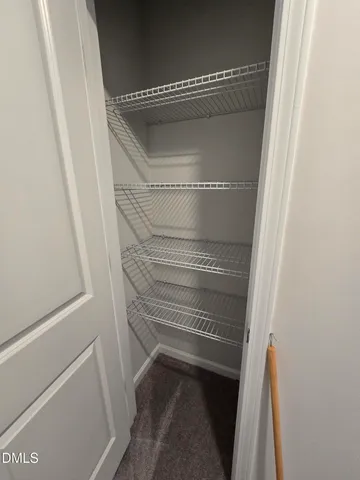 an empty room with windows and mirror