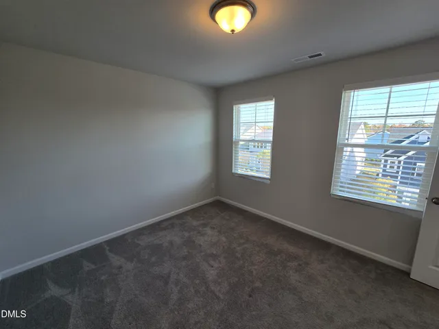 an empty room with closet and a bathroom