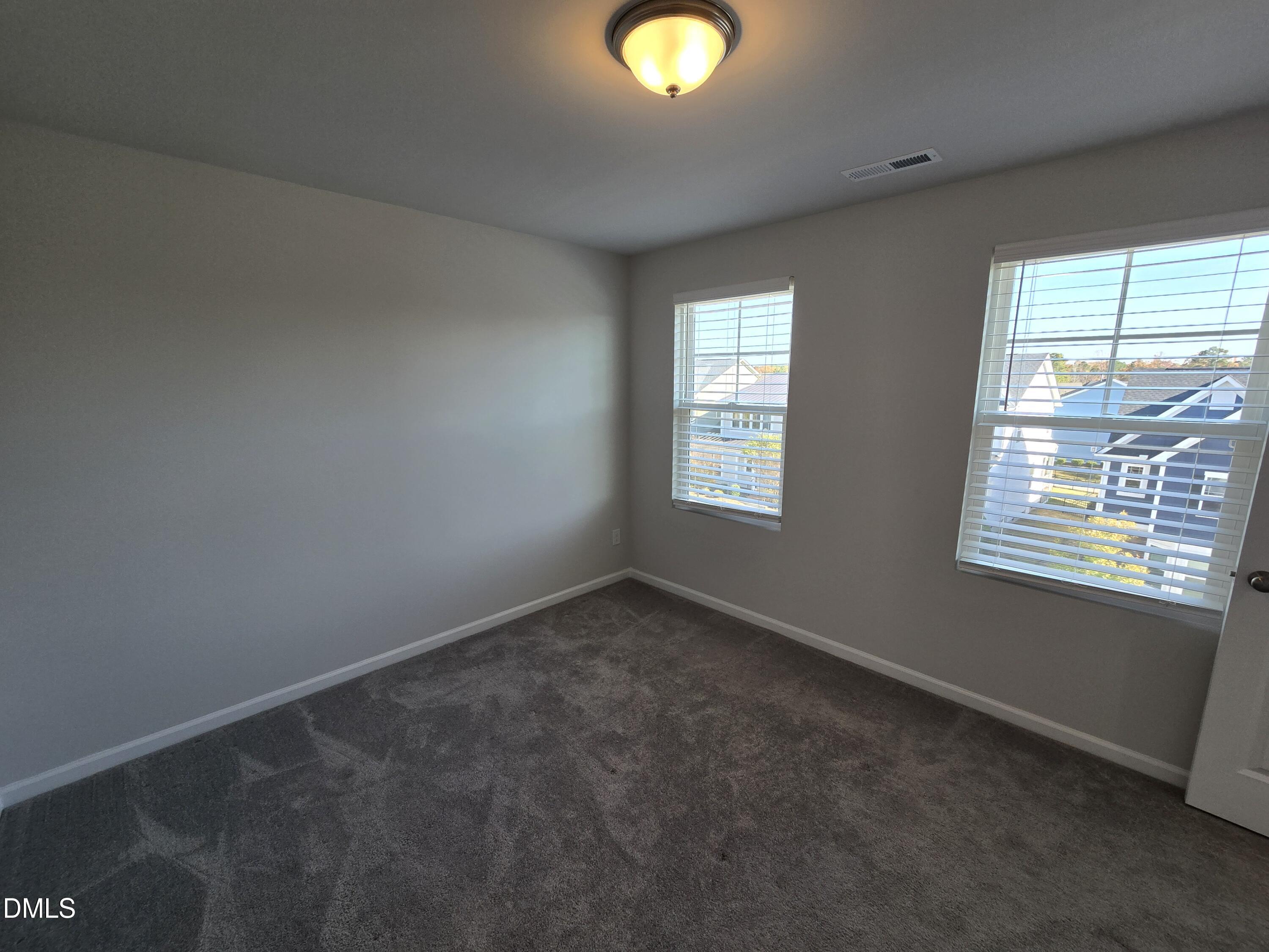 6309 Truxton Lane Raleigh, NC 27616 - Photo 38 of 41 an empty room with windows and mirror