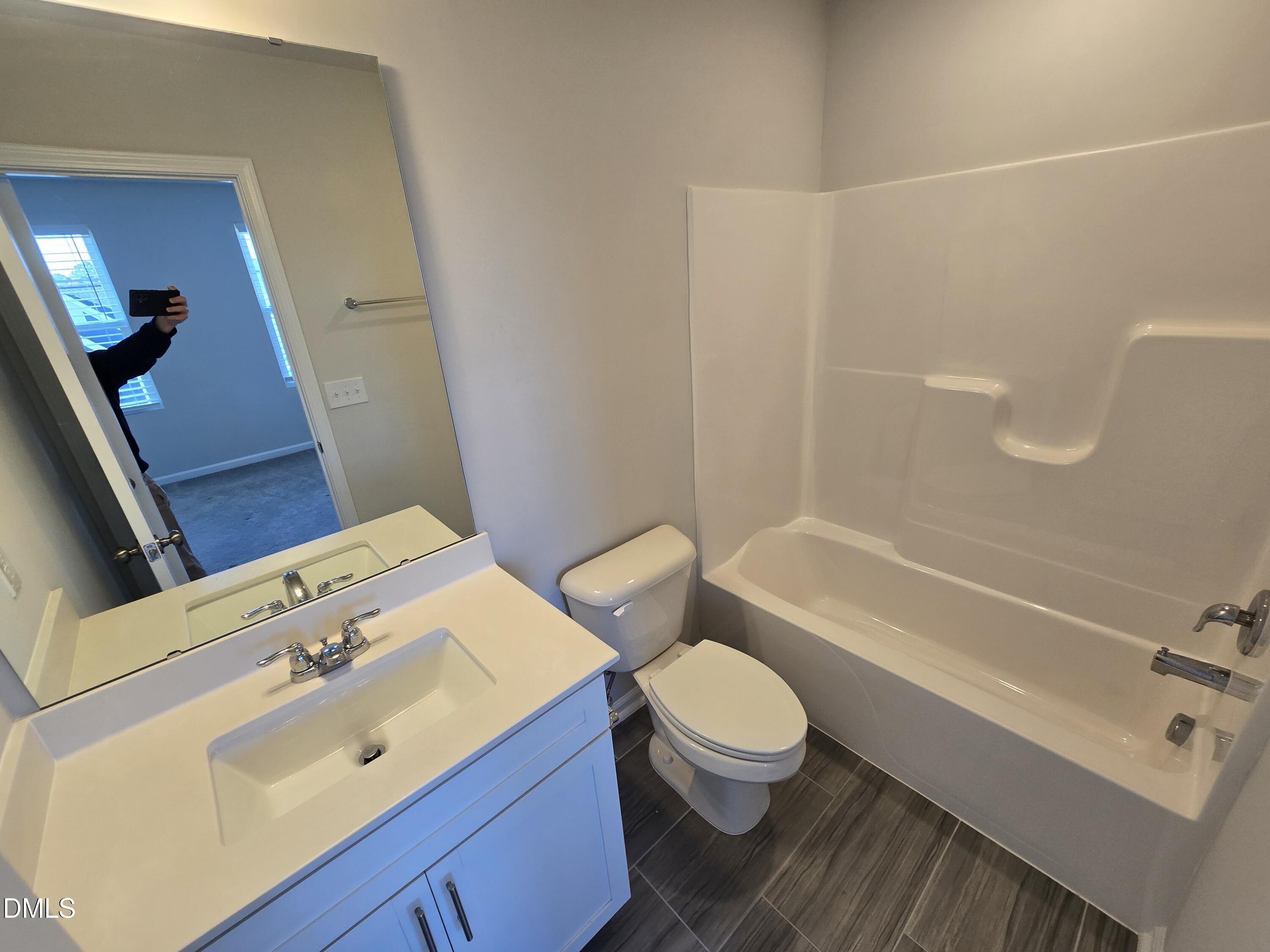 6309 Truxton Lane Raleigh, NC 27616 - Photo 41 of 41 a bathroom with a sink a toilet and bathtub