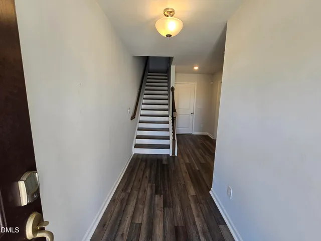 a view of entryway and hall with wooden floor