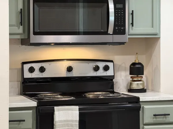 a stove top oven sitting inside of a kitchen