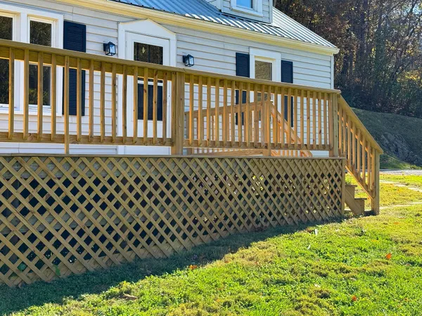 a view of a house with wooden fence