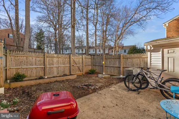 a view of a backyard with wooden fence