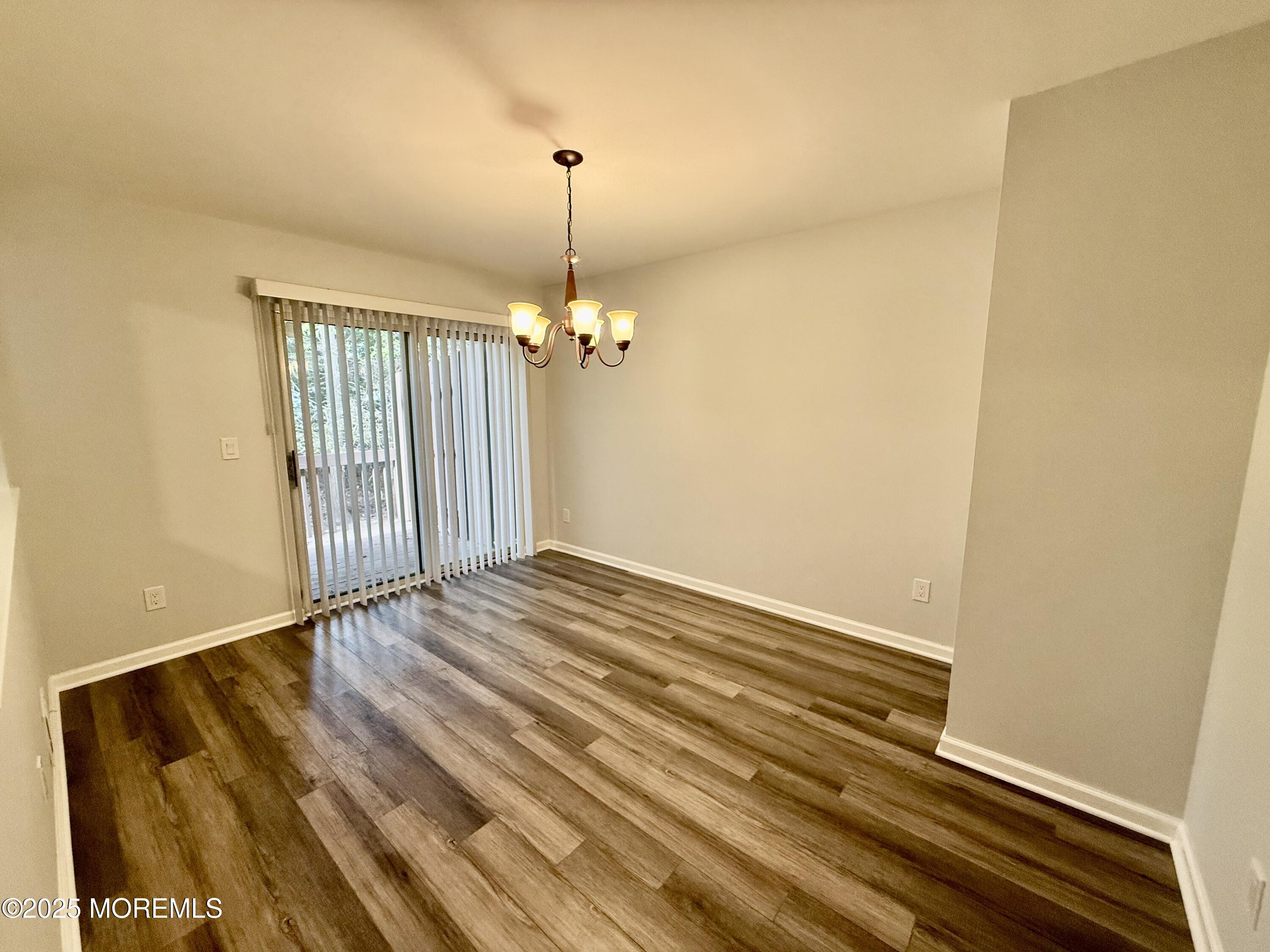 28 Atrium Way Manalapan, NJ 07726 - Photo 4 of 13 a view of empty room with wooden floor