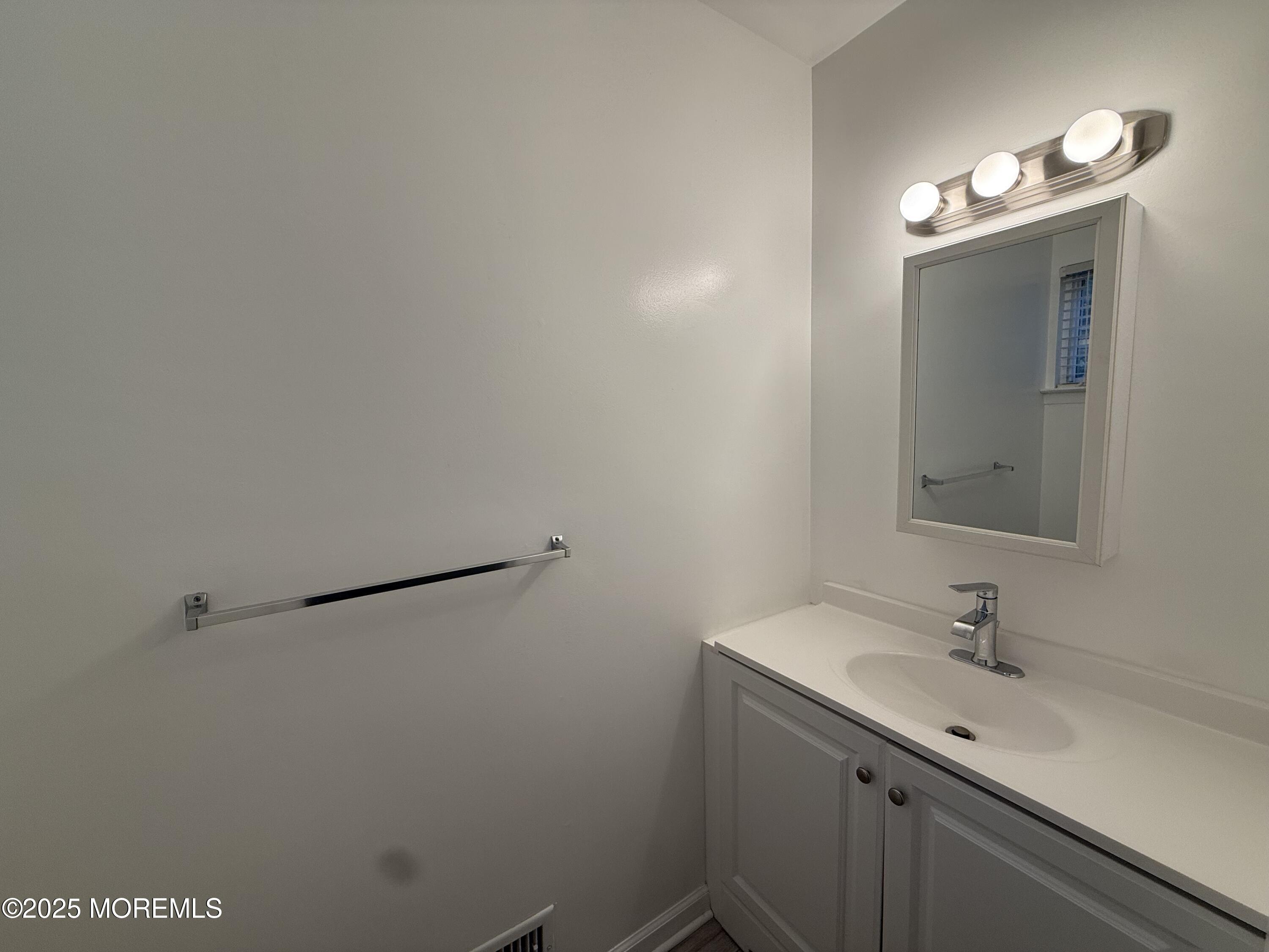 28 Atrium Way Manalapan, NJ 07726 - Photo 6 of 13 a bathroom with a sink and a mirror