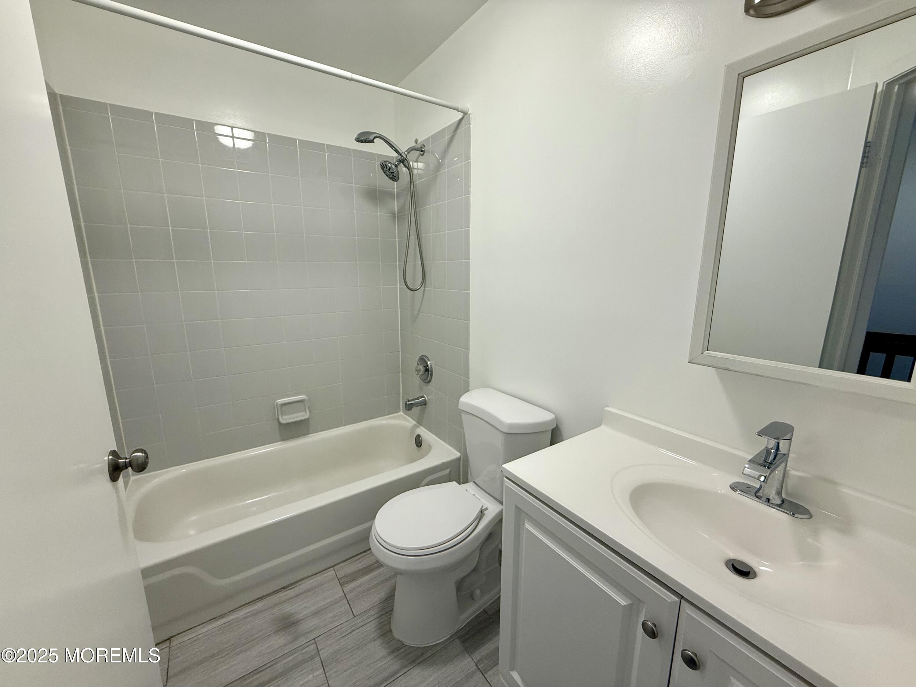 28 Atrium Way Manalapan, NJ 07726 - Photo 8 of 13 a bathroom with a sink a toilet and shower