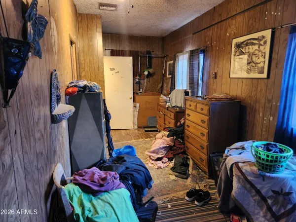 a view of a patio with table and chairs potted plants and large tree