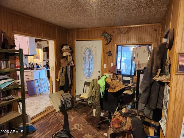 a view of a workspace with furniture and clutter