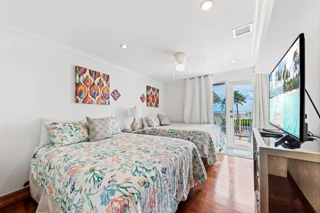 a bedroom with a large bed and a flat screen tv