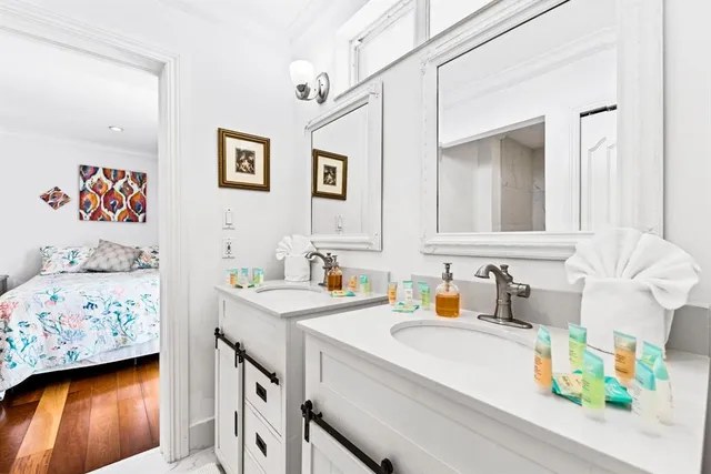 a bathroom with a sink mirror and vanity