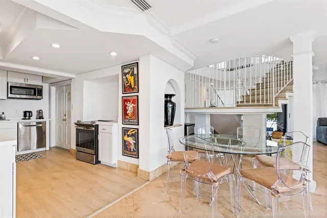 a kitchen with stainless steel appliances kitchen island granite countertop a refrigerator and cabinets