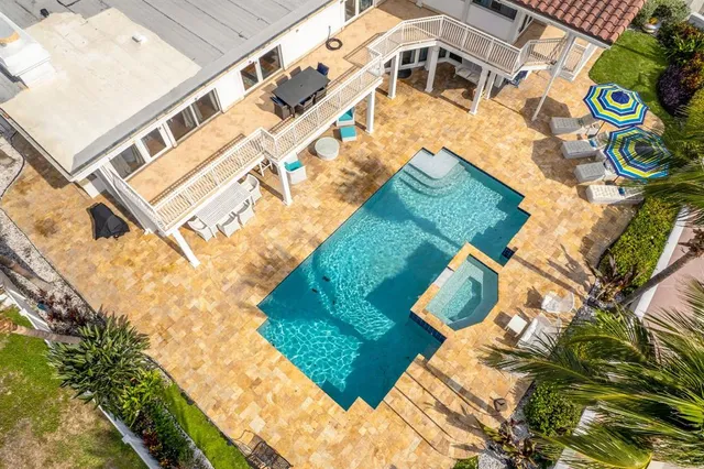 a view of a swimming pool with chairs