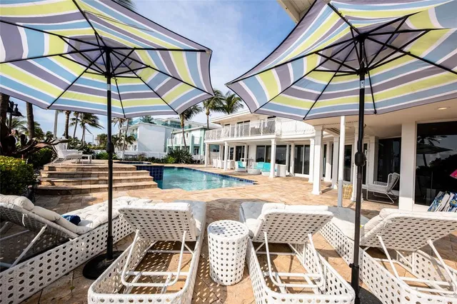 a backyard of a house with barbeque oven table and chairs