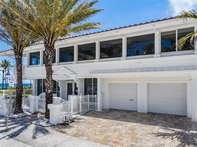 a view of a white house with large windows