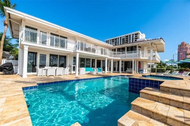 a front view of a house with swimming pool having outdoor seating