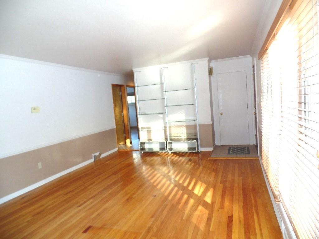 425 Kurt Drive Pittsburgh, PA 15243 - Photo 13 of 43 a view of an empty room with wooden floor and a window