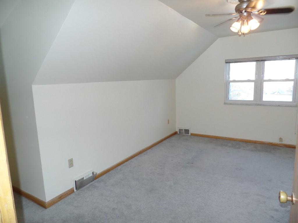 425 Kurt Drive Pittsburgh, PA 15243 - Photo 14 of 43 an empty room with a chandelier fan and windows