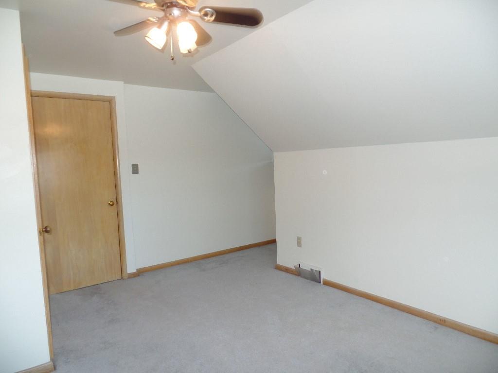 425 Kurt Drive Pittsburgh, PA 15243 - Photo 15 of 43 an empty room with a chandelier fan and windows