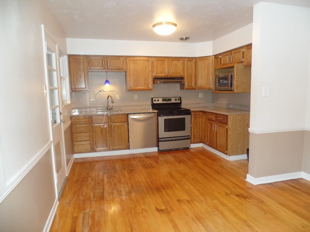 425 Kurt Drive Pittsburgh, PA 15243 - Photo 17 of 43 a large kitchen with stainless steel appliances granite countertop a stove a sink and a refrigerator