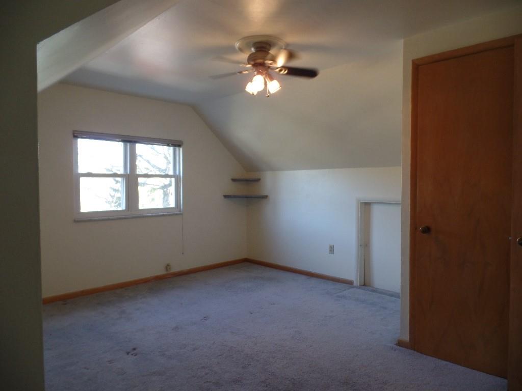 425 Kurt Drive Pittsburgh, PA 15243 - Photo 31 of 43 an empty room with a chandelier fan and windows