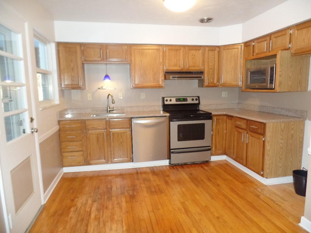 425 Kurt Drive Pittsburgh, PA 15243 - Photo 4 of 43 a kitchen with stainless steel appliances a stove a sink and a microwave
