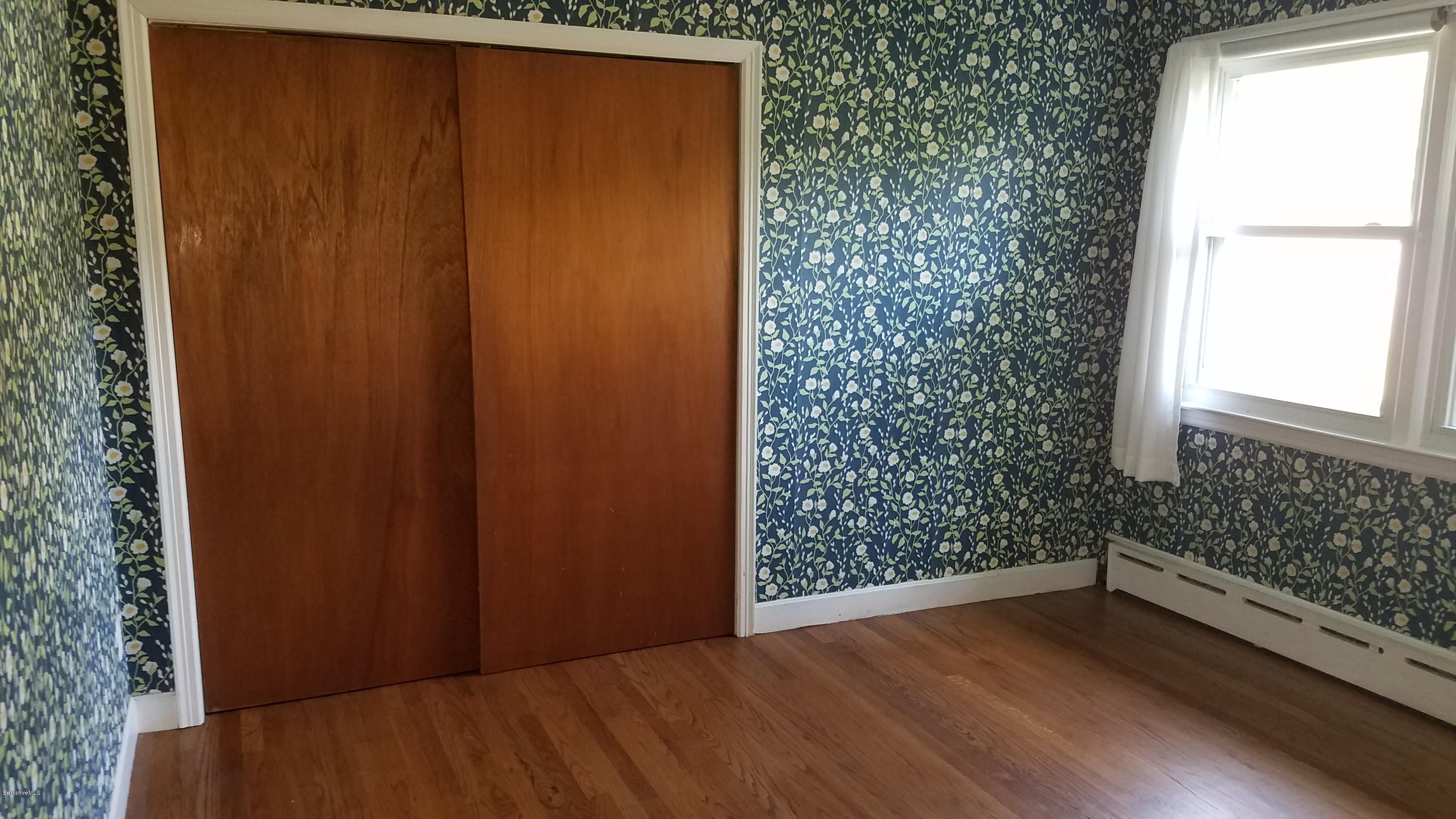 429 Hancock Road Williamstown, MA 01267 - Photo 12 of 33 an empty room with wooden floor and windows
