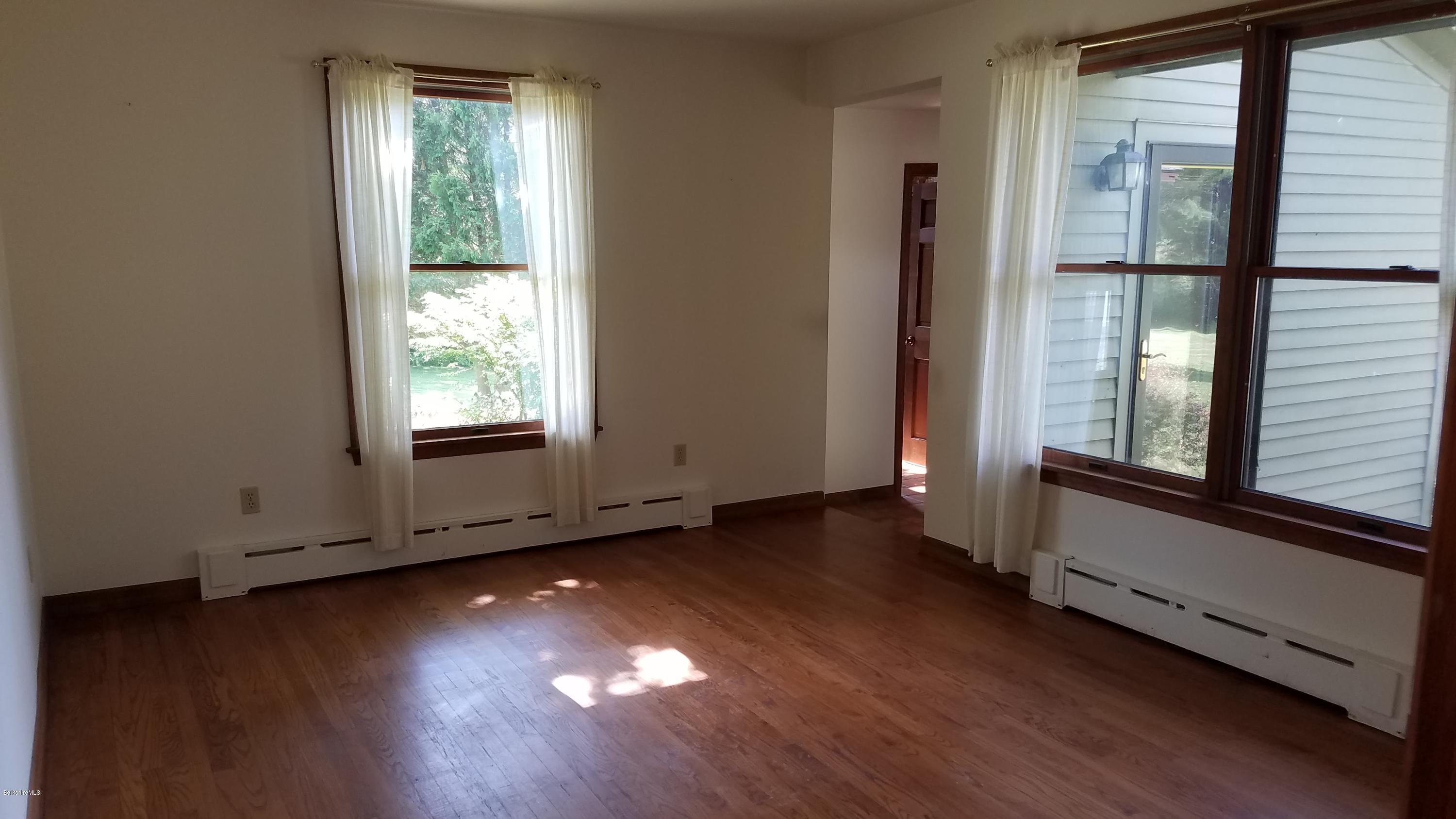 429 Hancock Road Williamstown, MA 01267 - Photo 18 of 33 an empty room with wooden floor and windows