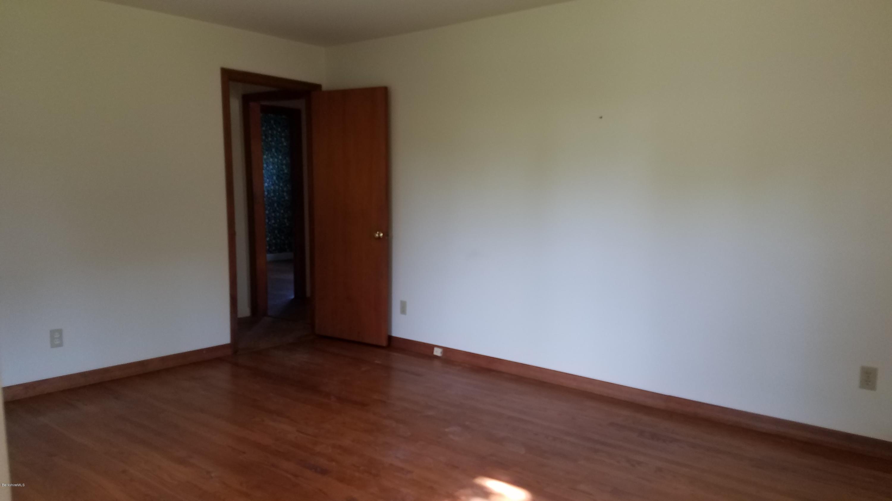 429 Hancock Road Williamstown, MA 01267 - Photo 19 of 33 a view of an empty room with wooden floor and closet
