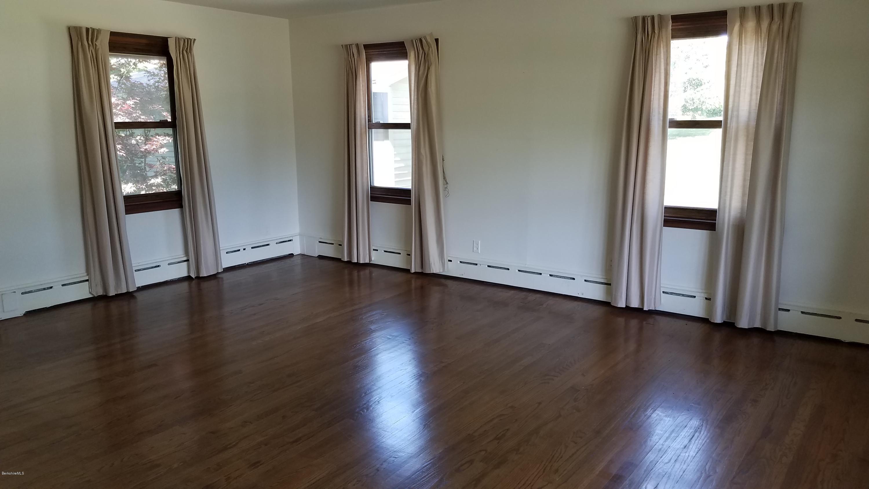 429 Hancock Road Williamstown, MA 01267 - Photo 3 of 33 an empty room with wooden floor and windows