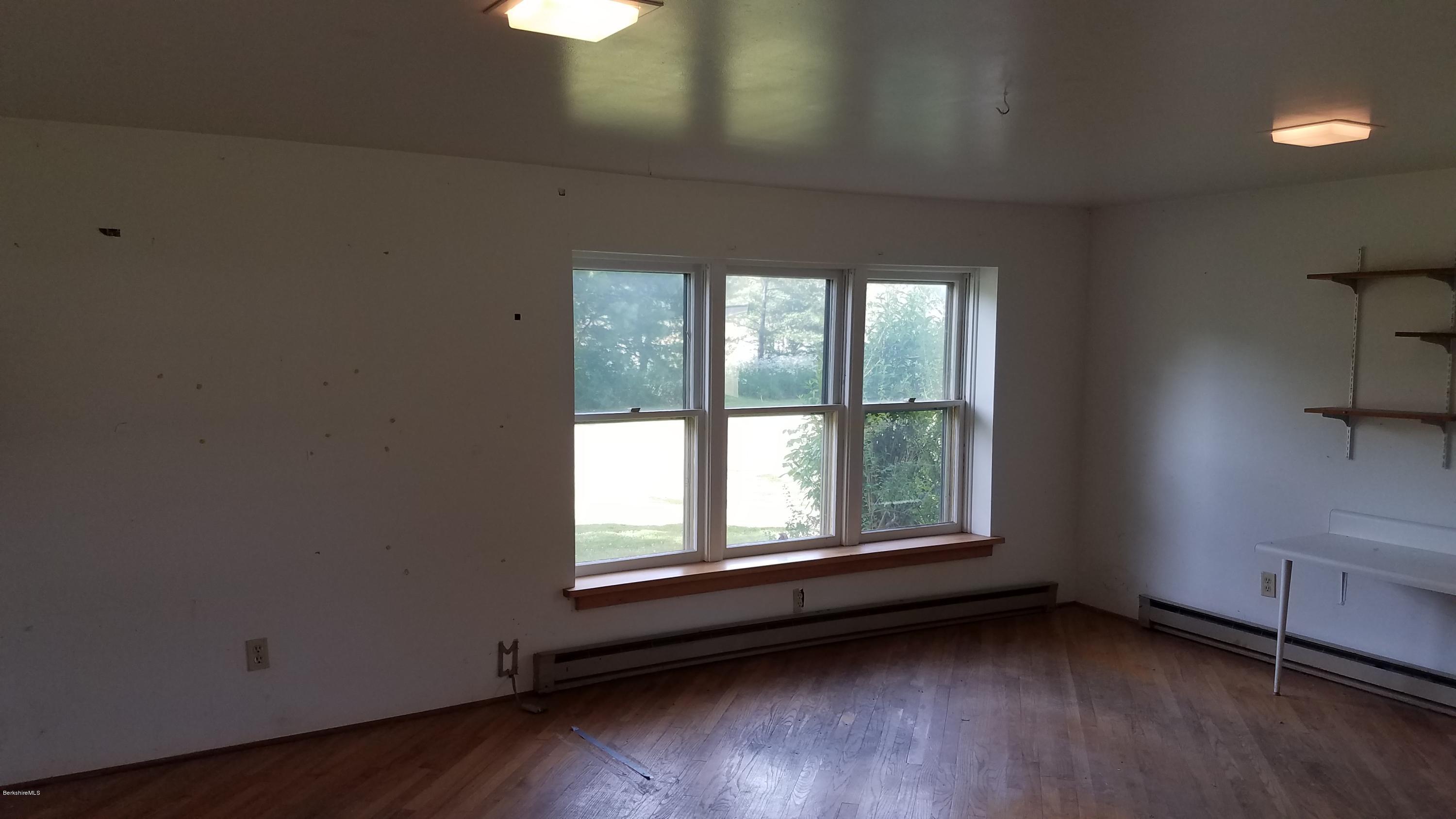 429 Hancock Road Williamstown, MA 01267 - Photo 22 of 33 an empty room with wooden floor and windows