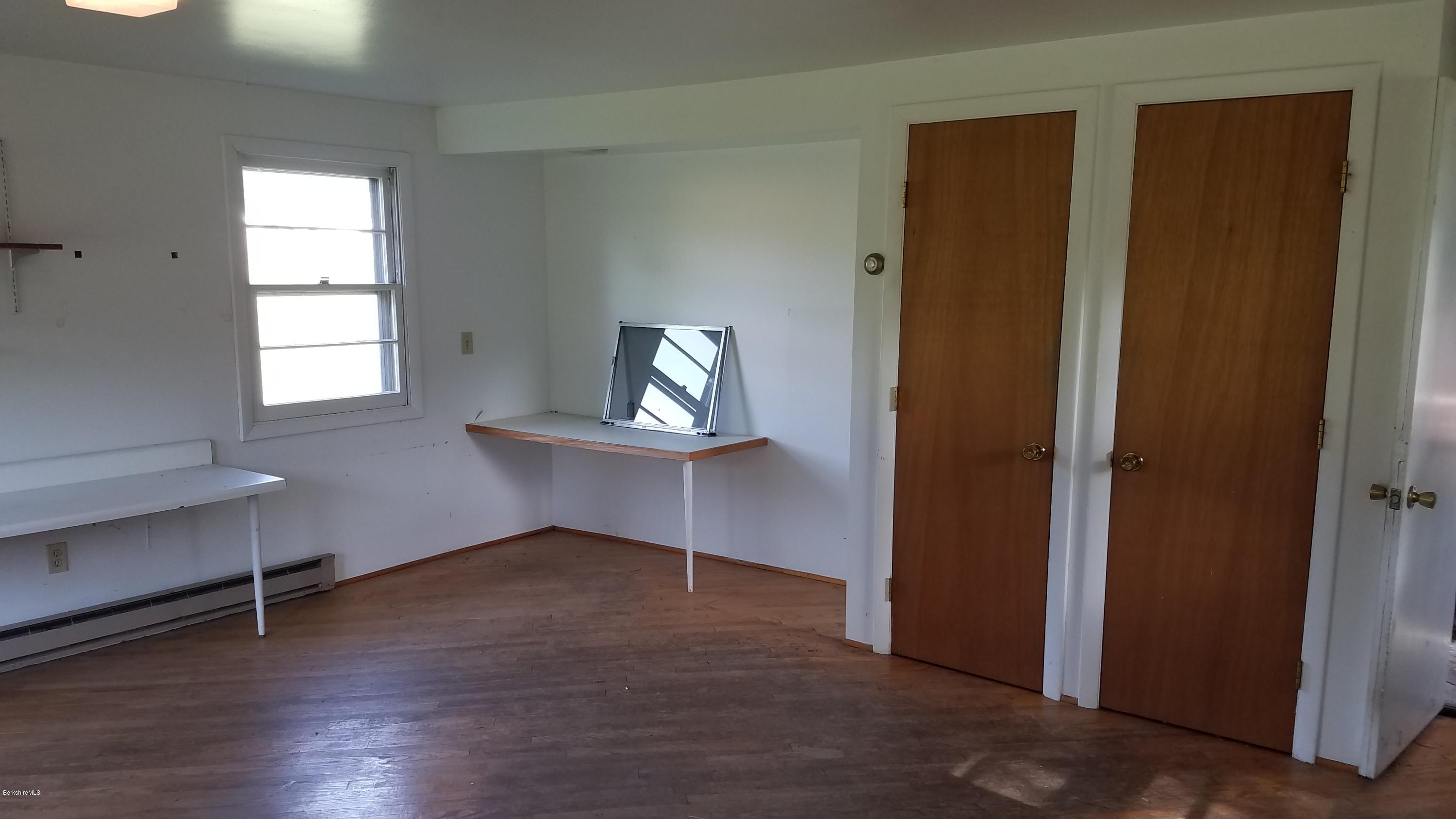 429 Hancock Road Williamstown, MA 01267 - Photo 24 of 33 a view of empty room with wooden floor and fan