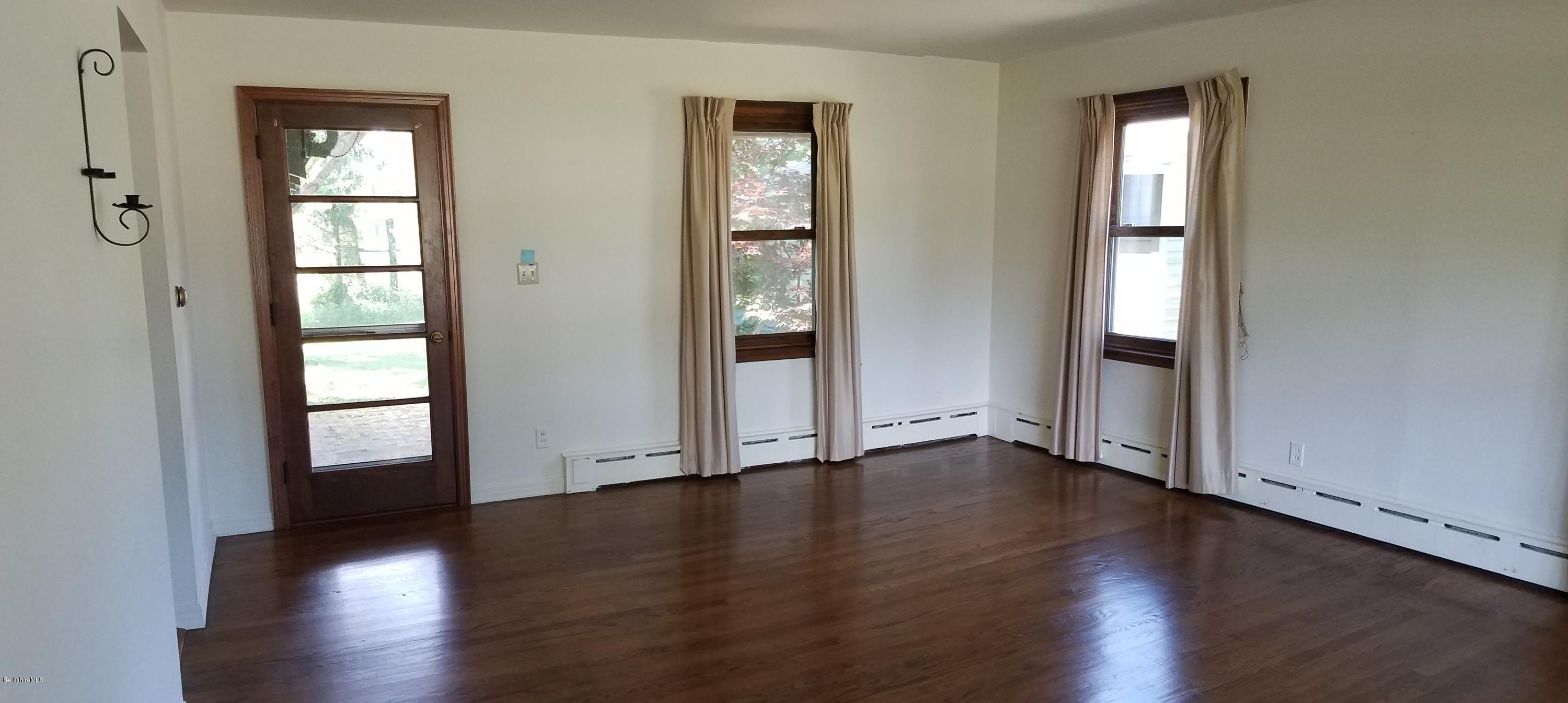 429 Hancock Road Williamstown, MA 01267 - Photo 4 of 33 an empty room with wooden floor and windows