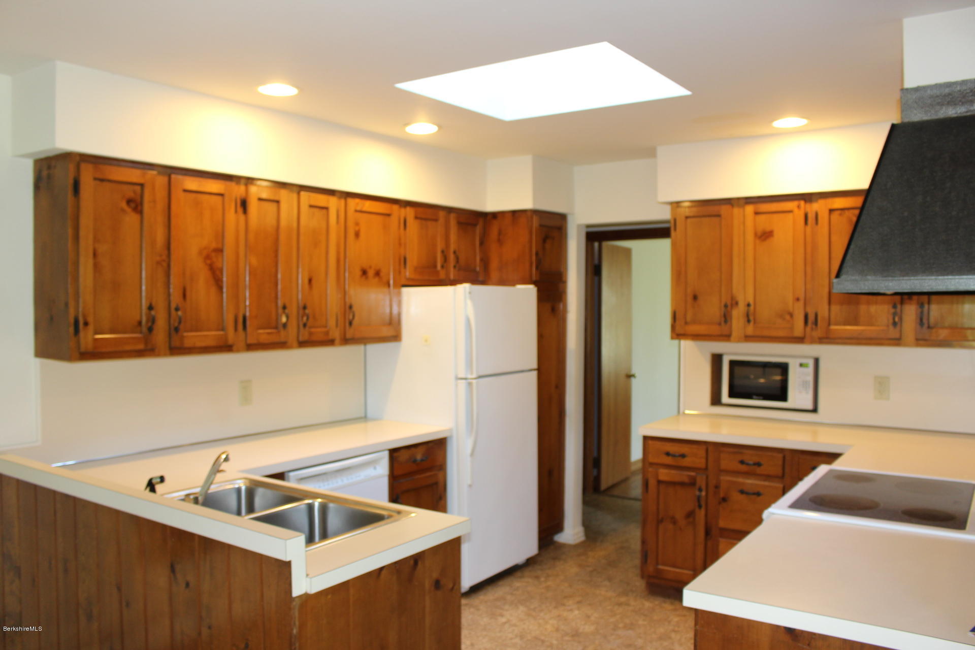 429 Hancock Road Williamstown, MA 01267 - Photo 5 of 33 a kitchen with stainless steel appliances a refrigerator and a stove top oven