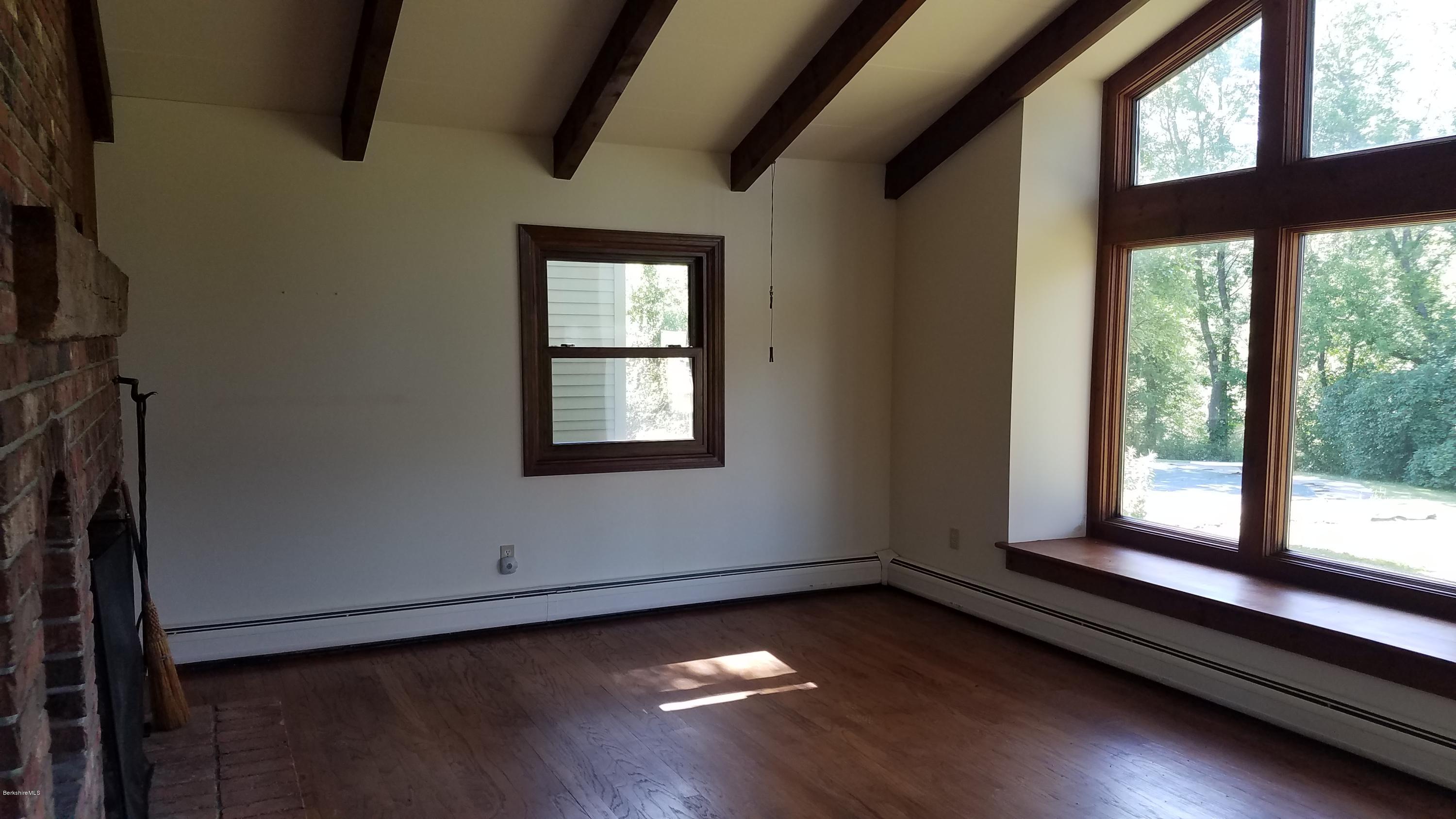 429 Hancock Road Williamstown, MA 01267 - Photo 10 of 33 a view of an empty room with wooden floor and a window