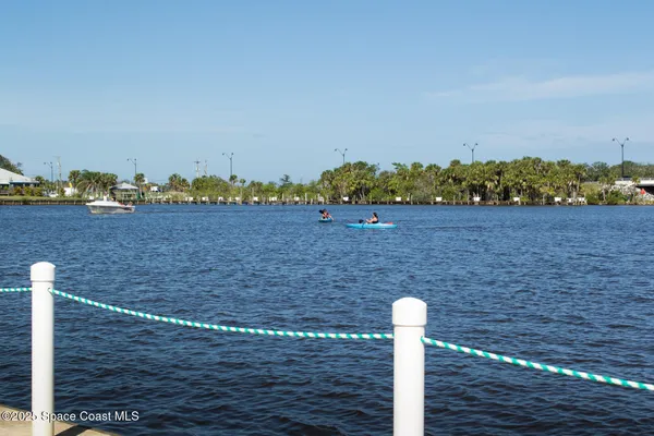 a view of a lake with boats and trees in the background
