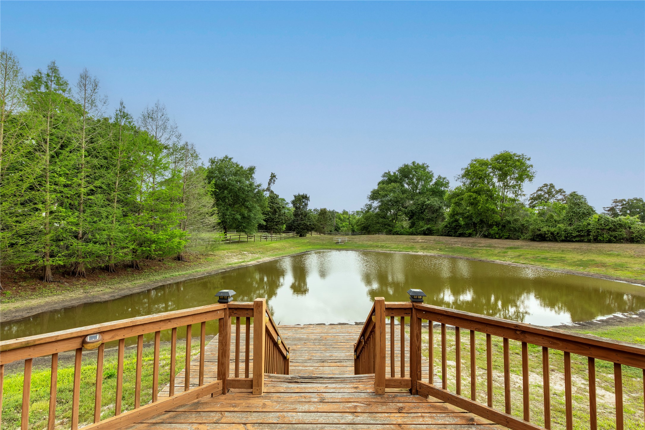 119 Heritage Trail Bellville, TX 77418 - Photo 17 of 20 a view of a wooden deck and lake