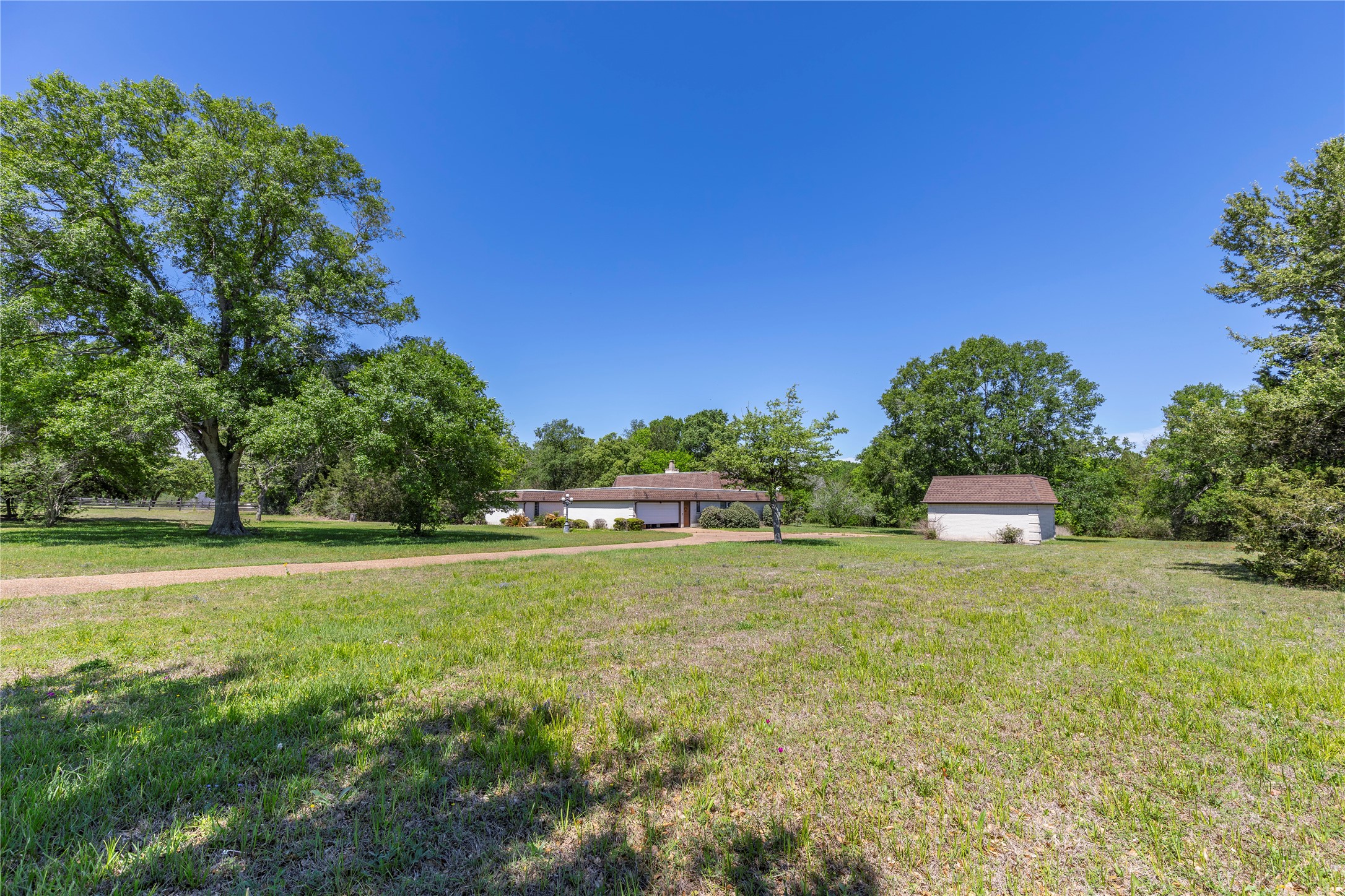 119 Heritage Trail Bellville, TX 77418 - Photo 6 of 20 a backyard of a house with lots of green space and fog