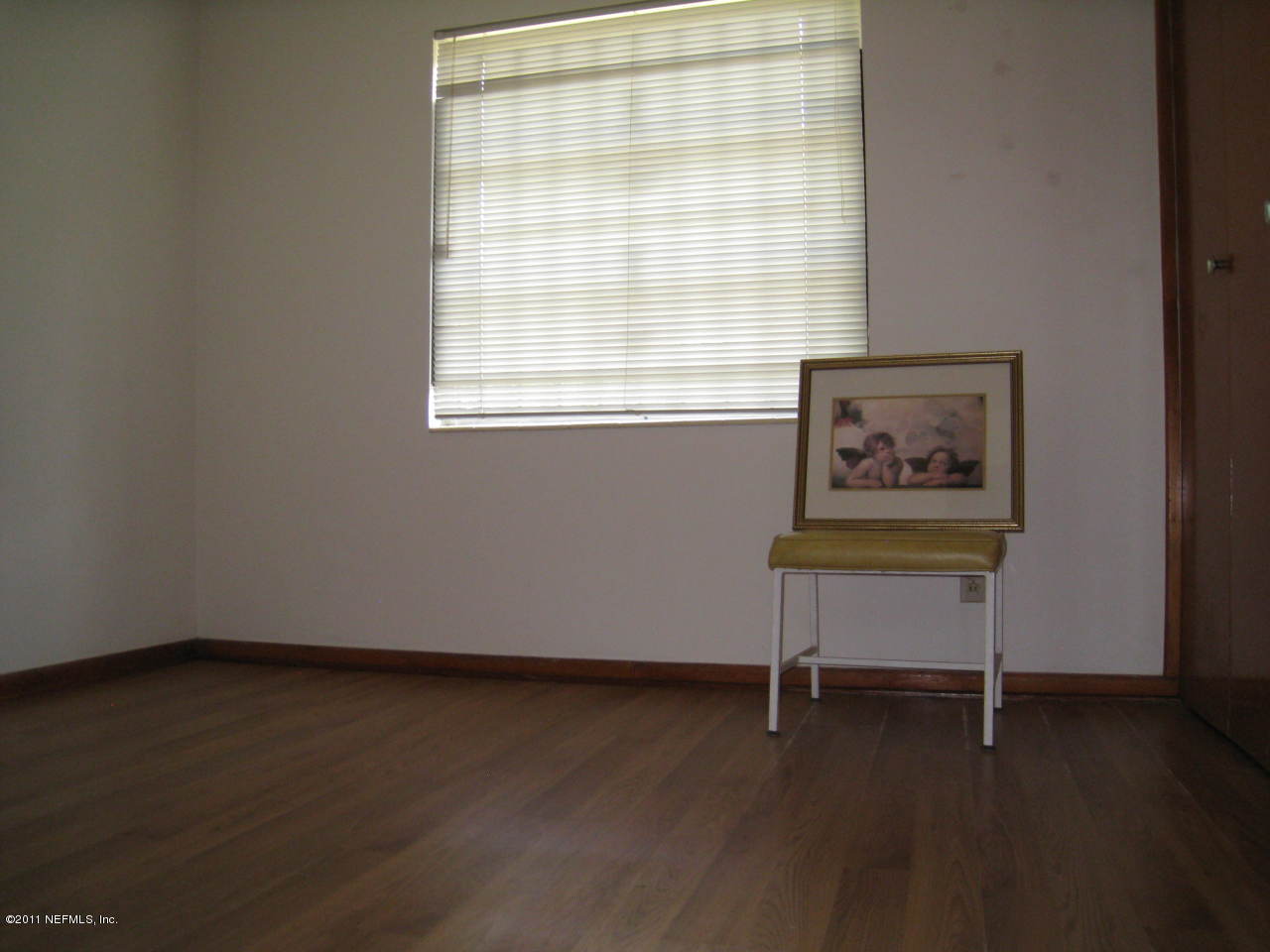 7418 Centauri Road Jacksonville, FL 32210 - Photo 13 of 22 a view of a room with wooden floor and a window