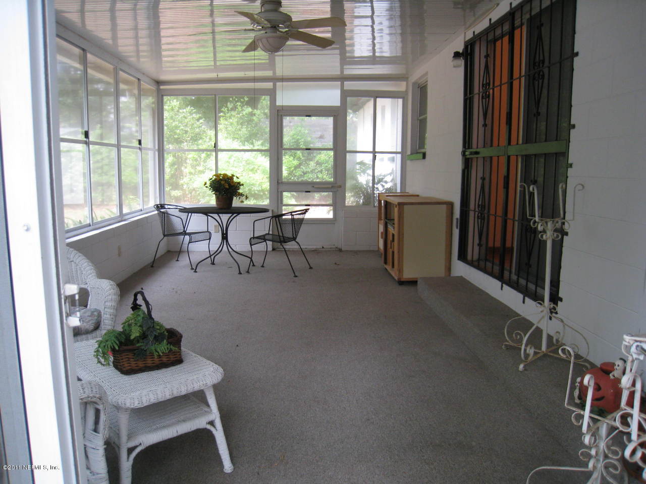 7418 Centauri Road Jacksonville, FL 32210 - Photo 17 of 22 a living room with furniture and a floor to ceiling window
