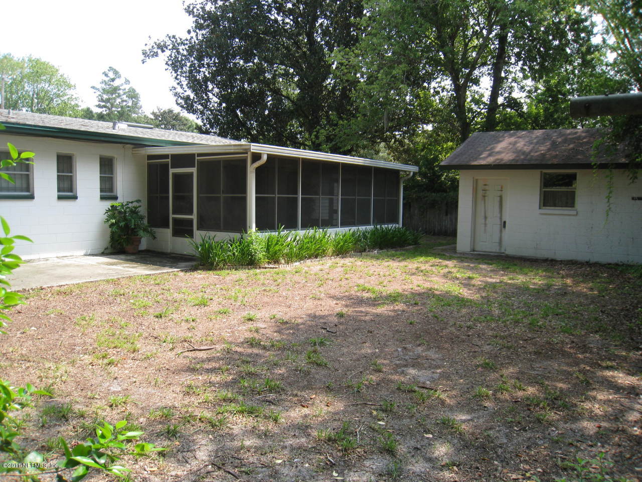 7418 Centauri Road Jacksonville, FL 32210 - Photo 21 of 22 a view of a house with a yard and potted plants