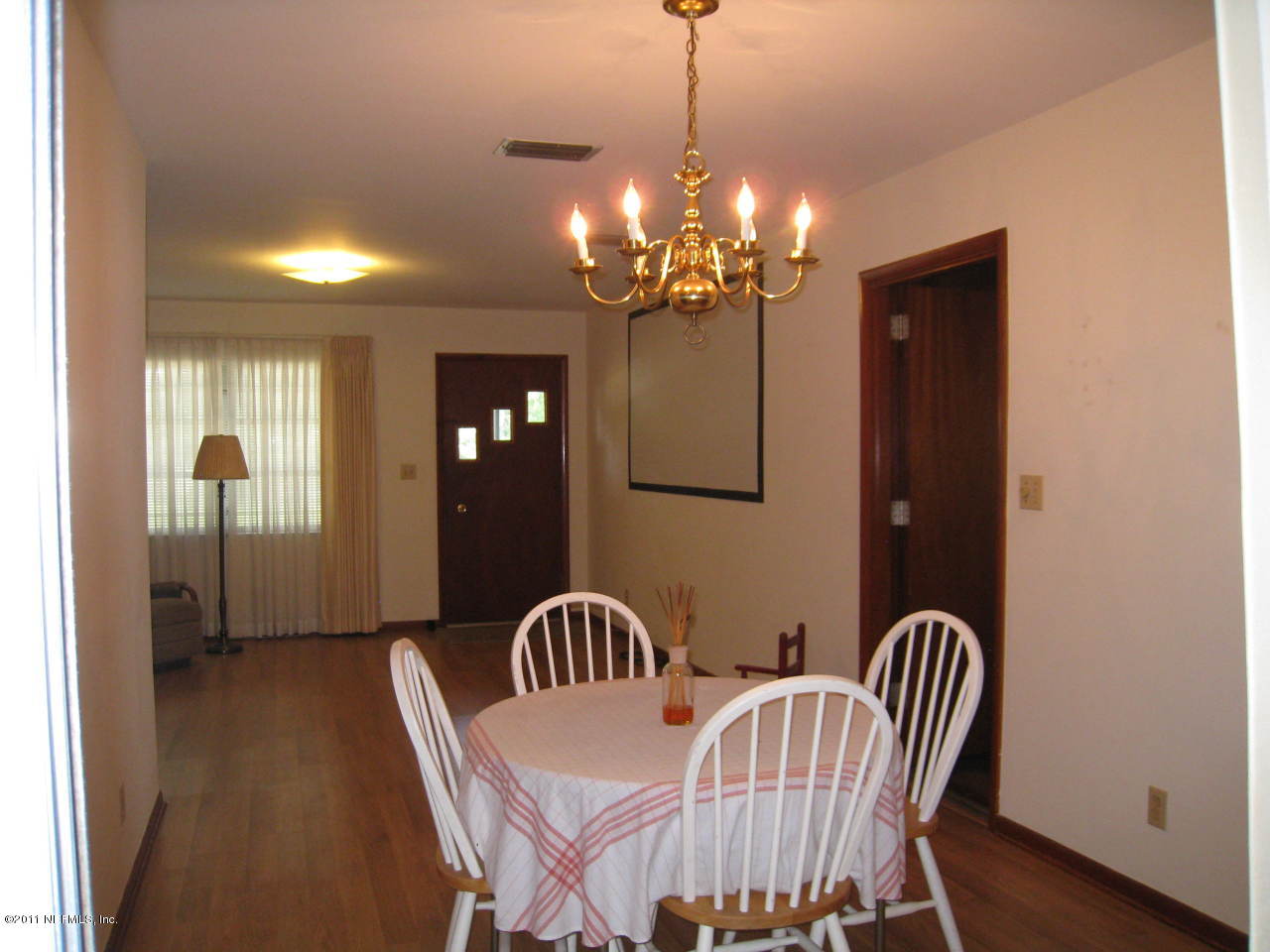 7418 Centauri Road Jacksonville, FL 32210 - Photo 3 of 22 a view of a dining room with furniture and chandelier