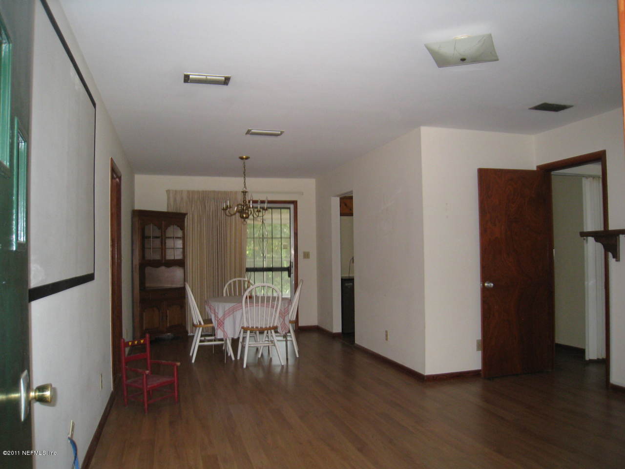 7418 Centauri Road Jacksonville, FL 32210 - Photo 6 of 22 a view of a room with wooden floor lounge chair and windows